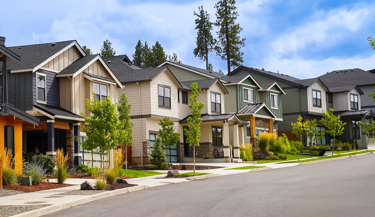 A quiet residential neighborhood of family homes under a clear blue sky